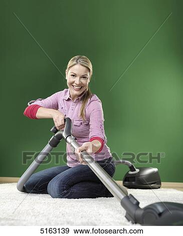 Stock Photo - Woman hoovering . Fotosearch