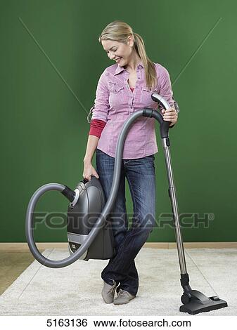Woman hoovering View Large Photo Image Stock Photograph - Woman hoovering . Fotosearch