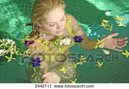 Woman in swimming pool with flowers View Large Photo Image Stock Image - Woman in swimming pool with flowers . Fotosearch