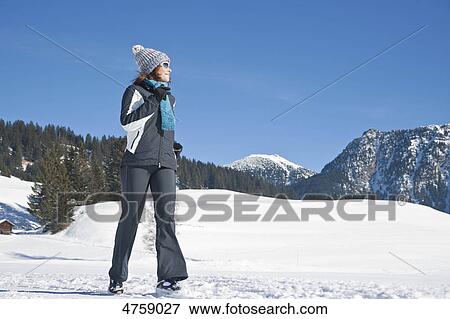 Stock Photo - Woman jogging in winter landscape, Tannheimer Tal, Tyrol, Austria . Fotosearch