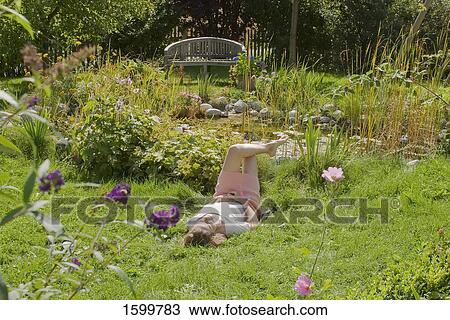 Woman lying in lawn View Large Photo Image Stock Image - Woman lying in lawn . Fotosearch
