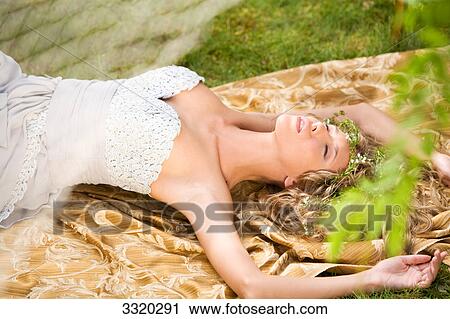 Woman lying on a blanket outdoors, high angle view View Large Photo Image Stock Image - Woman lying on a blanket outdoors, high angle view . Fotosearch