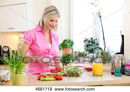 Woman preparing salad in kitchen View Large Photo Image Stock Photo - Woman preparing salad in kitchen . Fotosearch