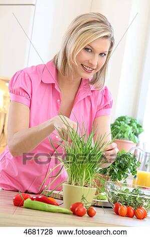 Woman preparing salad in kitchen View Large Photo Image Stock Photo - Woman preparing salad in kitchen . Fotosearch
