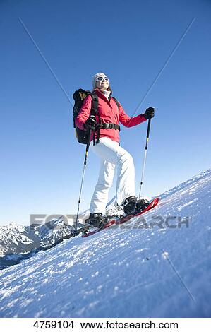 Woman snow hiking, Tannheimer Tal, Tyrol, Austria View Large Photo Image Picture - Woman snow hiking, Tannheimer Tal, Tyrol, Austria . Fotosearch