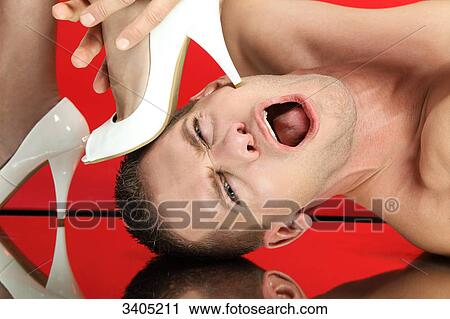 Woman stepping on mans face, close-up View Large Photo Image Stock Image - Woman stepping on mans face, close-up . Fotosearch