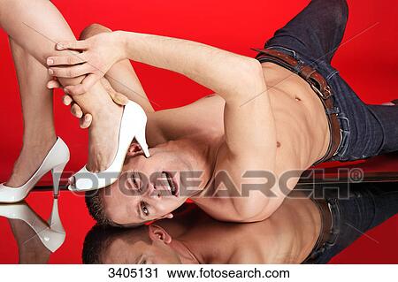 Stock Image - Woman stepping on mans face . Fotosearch