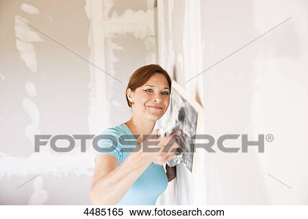 Woman with brick trowel View Large Photo Image Stock Photography - Woman with brick trowel . Fotosearch