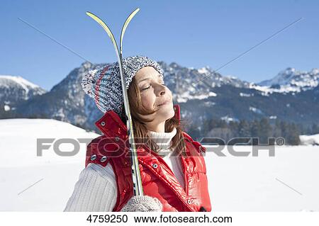 Woman with skis in winter landscape, Tannheimer Tal, Tyrol, Austria View Large Photo Image Stock Image - Woman with skis in winter landscape, Tannheimer Tal, Tyrol, Austria . Fotosearch