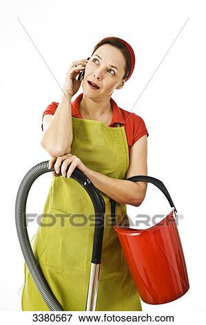 Woman with vacuum cleaner and cleaning bucket phoning View Large Photo Image Stock Photo - Woman with vacuum cleaner and cleaning bucket phoning . Fotosearch