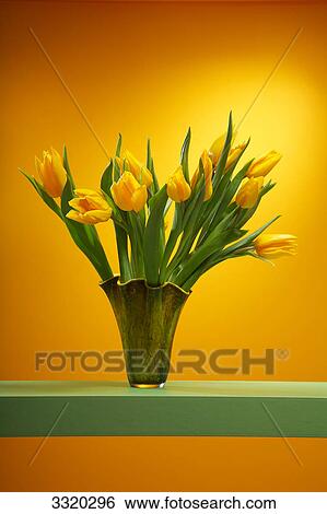 Stock Photograph - Yellow tulips in flower vase . Fotosearch