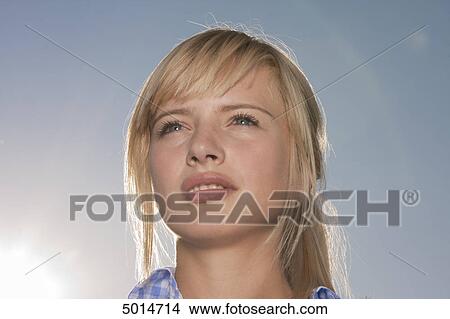 Young blond woman under blue sky View Large Photo Image Picture - Young blond woman under blue sky . Fotosearch