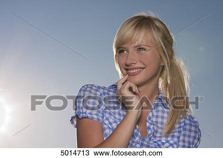Young blond woman wearing checkered blouse outdoors View Large Photo Image Stock Image - Young blond woman wearing checkered blouse outdoors . Fotosearch