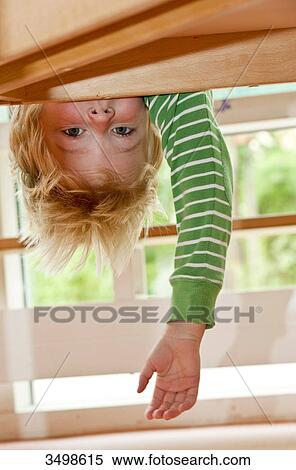 Young boy hanging upside down, low angle view View Large Photo Image Stock Photography - Young boy hanging upside down, low angle view . Fotosearch