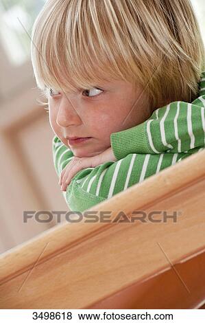 Stock Photo - Young boy lying on a table . Fotosearch