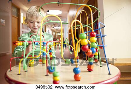 Young boy playing with an educational toy View Large Photo Image Stock Image - Young boy playing with an educational toy . Fotosearch