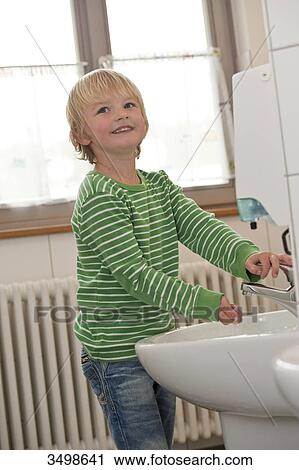 Young boy washing his hands View Large Photo Image Stock Image - Young boy washing his hands . Fotosearch