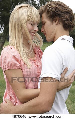 Young couple embracing outdoors View Large Photo Image Stock Photograph - Young couple embracing outdoors . Fotosearch