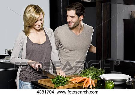 Picture - Young couple in kitchen . Fotosearch