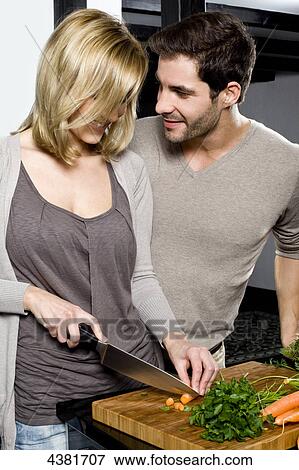 Young couple in kitchen View Large Photo Image Stock Photo - Young couple in kitchen . Fotosearch