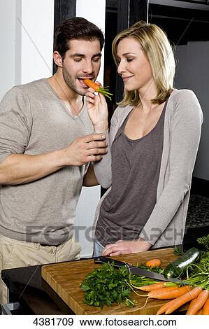 Young couple in kitchen View Large Photo Image Stock Photo - Young couple in kitchen . Fotosearch