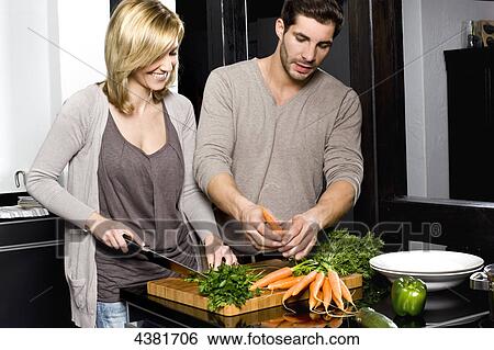Stock Photograph - Young couple in kitchen . Fotosearch