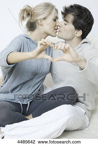 Young couple in love making heart with their hands View Large Photo Image Stock Image - Young couple in love making heart with their hands . Fotosearch