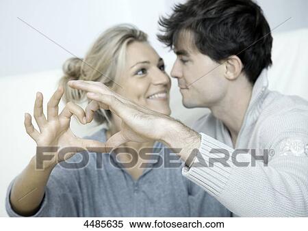 Young couple in love making heart with their hands View Large Photo Image Stock Photography - Young couple in love making heart with their hands . Fotosearch