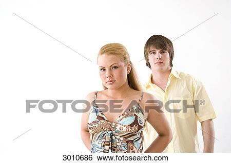 Young couple, looking at the camera, front view, studio shot View Large Photo Image Stock Photograph - Young couple, looking at the camera, front view, studio shot . Fotosearch