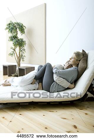 Young couple lying in bed View Large Photo Image Stock Image - Young couple lying in bed . Fotosearch