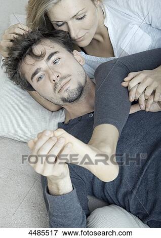 Young couple lying in bed View Large Photo Image Stock Photo - Young couple lying in bed . Fotosearch