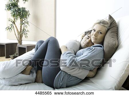 Young couple lying in bed View Large Photo Image Stock Photography - Young couple lying in bed . Fotosearch