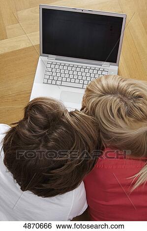 Young couple using laptop on the floor  View Large Photo Image Stock Photograph - Young couple using laptop on the floor . Fotosearch