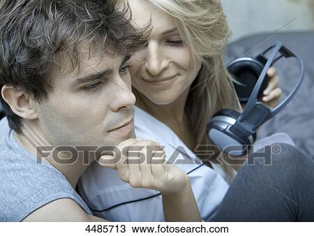 Young couple with headphones View Large Photo Image Stock Image - Young couple with headphones . Fotosearch