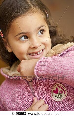 Young girl closing the zipper of her jacket, portrait View Large Photo Image Stock Image - Young girl closing the zipper of her jacket, portrait . Fotosearch