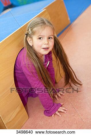 Young girl crawling out of a tunnel View Large Photo Image Stock Image - Young girl crawling out of a tunnel . Fotosearch