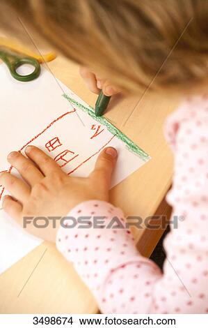 Young girl drawing a picture with a wax crayon, close-up View Large Photo Image Picture - Young girl drawing a picture with a wax crayon, close-up . Fotosearch
