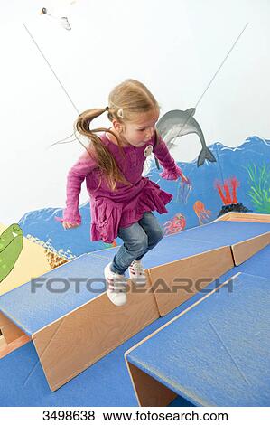 Young girl jumping over boxes, elevated view View Large Photo Image Stock Photo - Young girl jumping over boxes, elevated view . Fotosearch