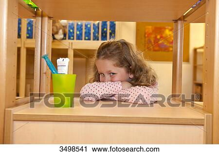 Young girl leaning against a shelf beside a toothbrush holder View Large Photo Image Stock Image - Young girl leaning against a shelf beside a toothbrush holder . Fotosearch