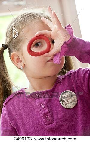 Young girl looking through a piece of plasticine, portrait View Large Photo Image Stock Image - Young girl looking through a piece of plasticine, portrait . Fotosearch