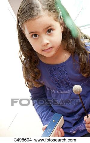 Young girl making music, elevated view View Large Photo Image Picture - Young girl making music, elevated view . Fotosearch