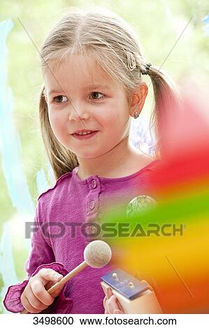 Young girl making music, low angle view View Large Photo Image Stock Image - Young girl making music, low angle view . Fotosearch