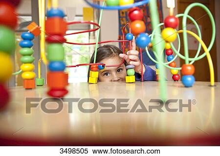 Young girl playing with an educational toy View Large Photo Image Stock Photography - Young girl playing with an educational toy . Fotosearch