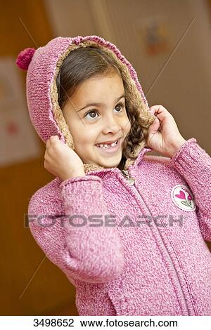 Young girl putting on a hood View Large Photo Image Stock Image - Young girl putting on a hood . Fotosearch