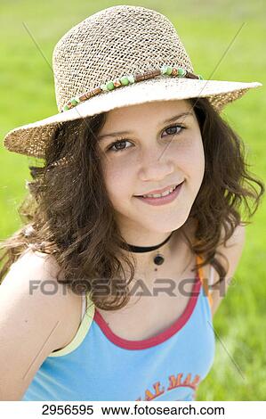 Young girl with straw hat, eye contact View Large Photo Image Stock Photography - Young girl with straw hat, eye contact . Fotosearch