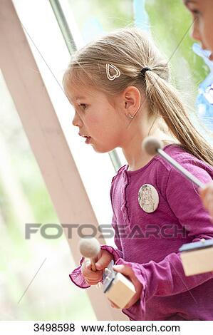 Young girls making music in a kindergarten, low angle view View Large Photo Image Stock Photo - Young girls making music in a kindergarten, low angle view . Fotosearch