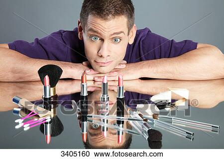 Young man looking at cosmetic products View Large Photo Image Stock Image - Young man looking at cosmetic products . Fotosearch