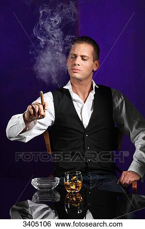 Stock Photograph - Young man smoking a cigar . Fotosearch
