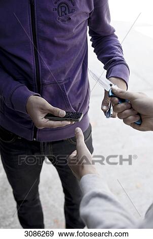 Young man threatening with a pocket knife View Large Photo Image Stock Photo - Young man threatening with a pocket knife . Fotosearch