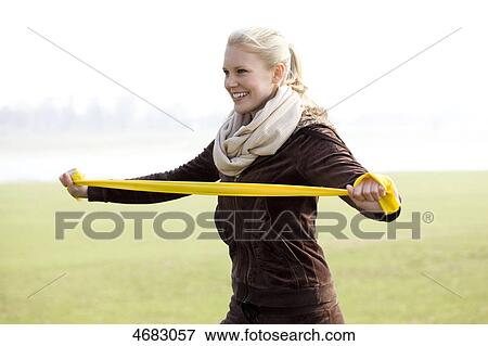 Stock Photo - Young woman doing workout . Fotosearch
